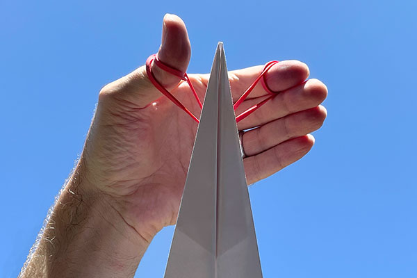 Finger and rubber band paper airplane launcher