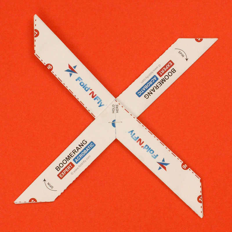 A paper boomerang in the shape of an X