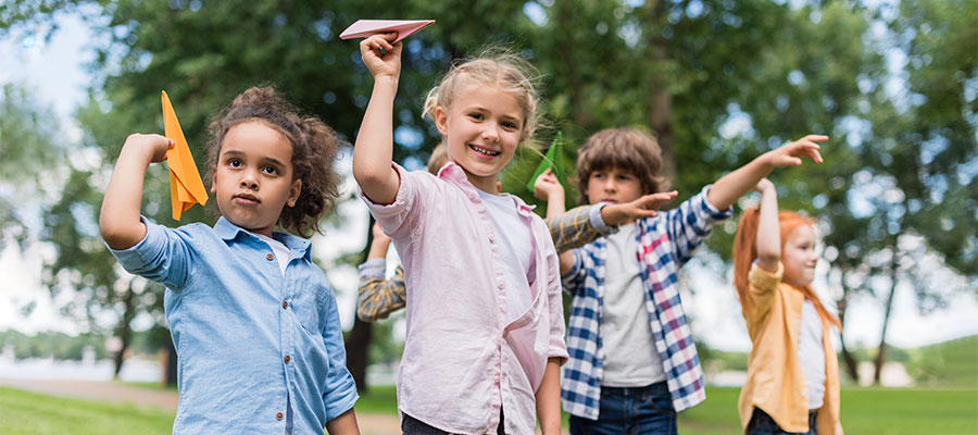 Kids playing with paper airplanes