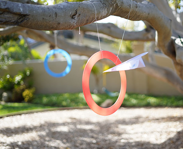 Throwing paper airplanes through rings